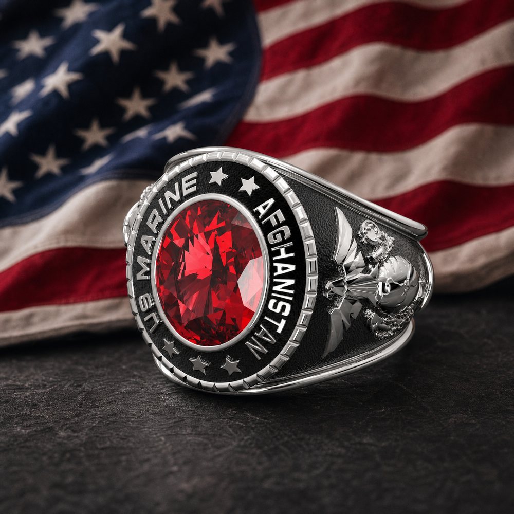 Sterling silver U.S. Marine ring with a red stone and Afghanistan engraving, in front of an American flag